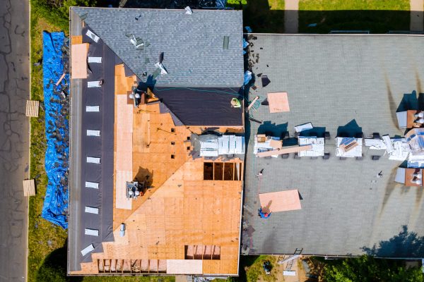 An apartment building roof was repaired by replacing old roof with new shingles and plywood